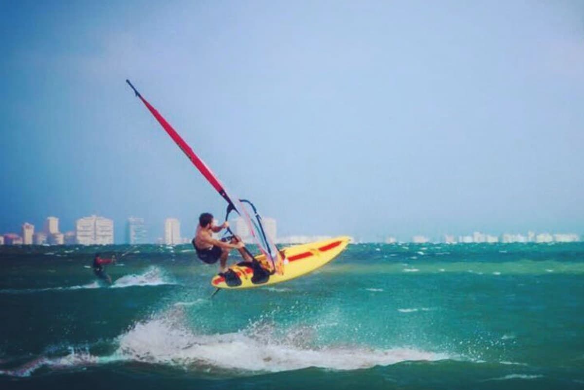 Un windsurfista salta sobre las olas en el Mar Menor